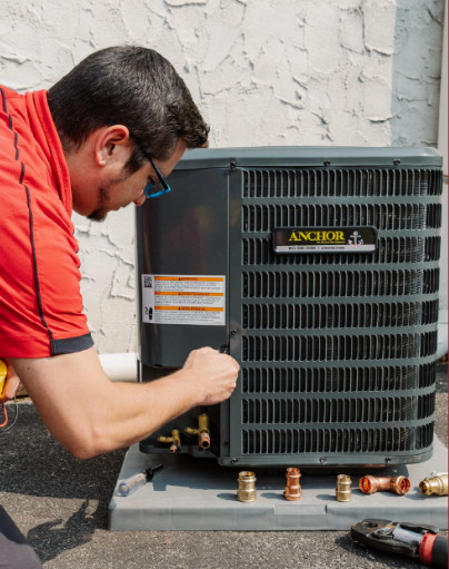 A man working on an AC unit